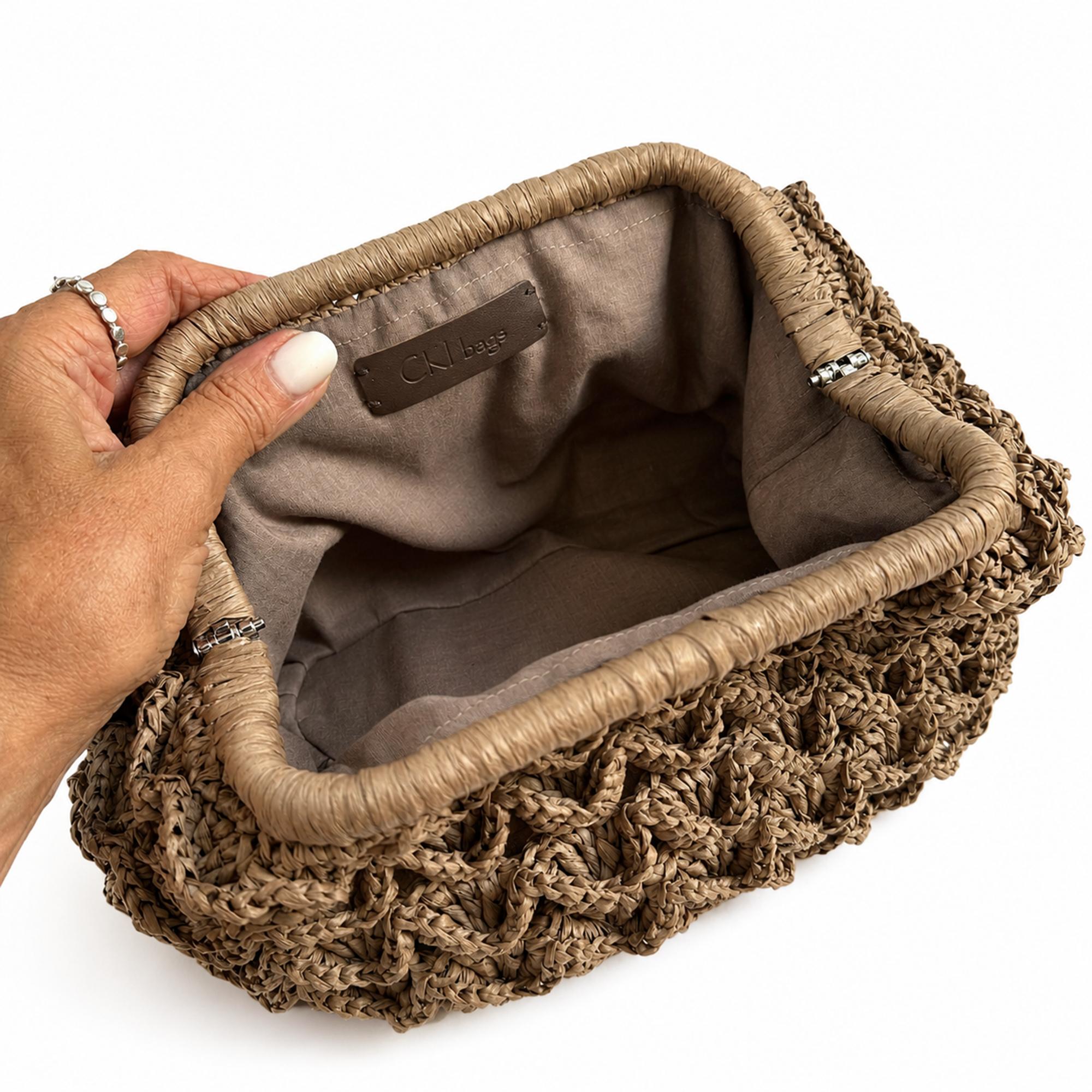 Interno della clutch Duna color beige scuro con fodera coordinata e finiture artigianali.